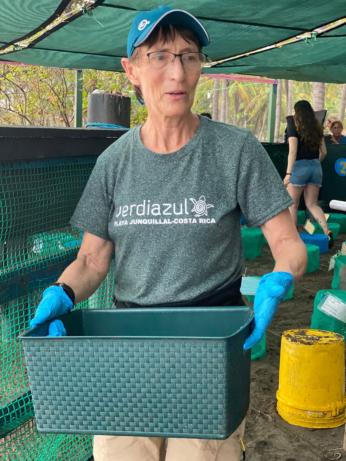 Carrying a basket of baby turtles on their way to release