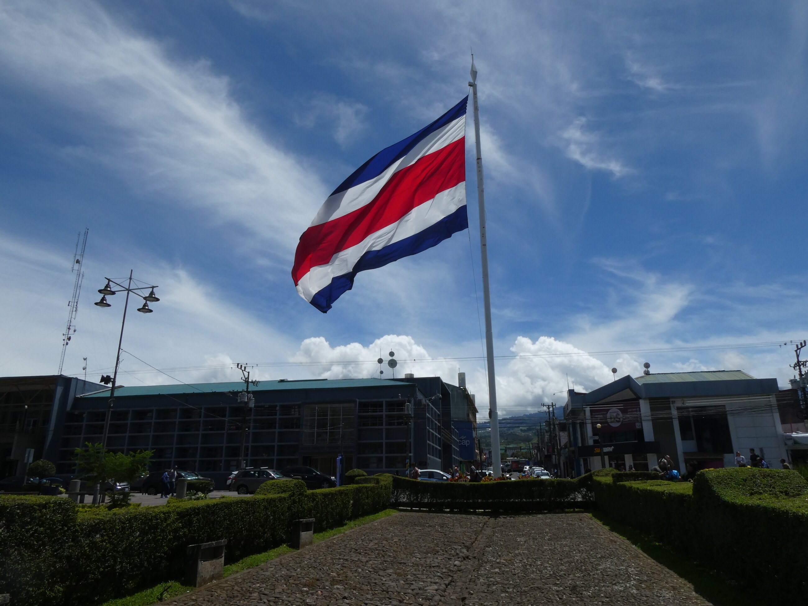 Large flag of Costa Rica in a city plaza.