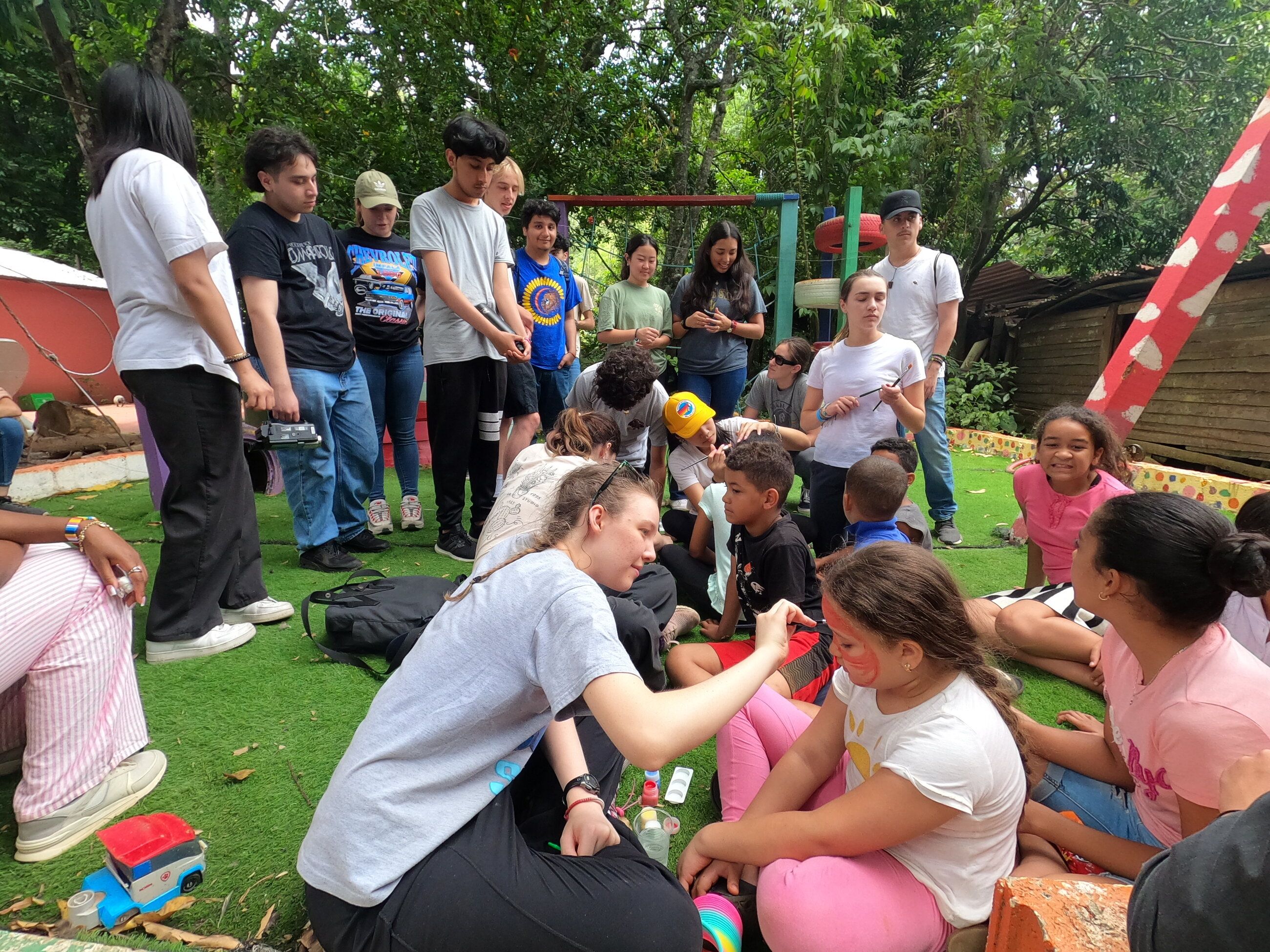 Face painting with kids at Sonido del Yaque