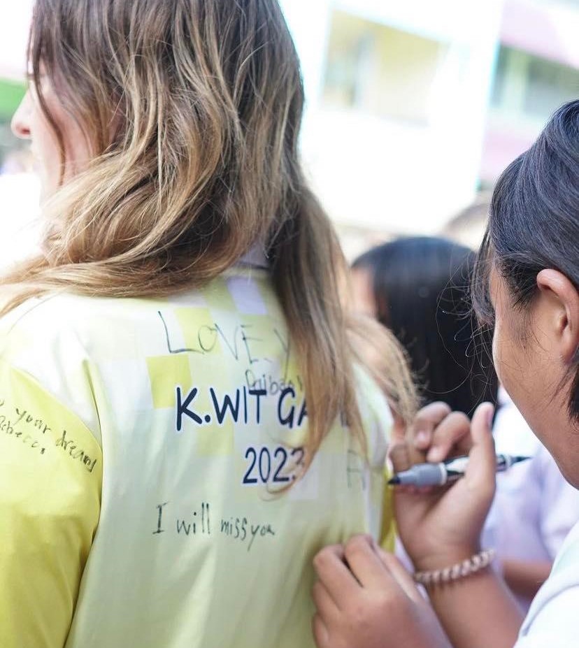 The students and staff signing our tops