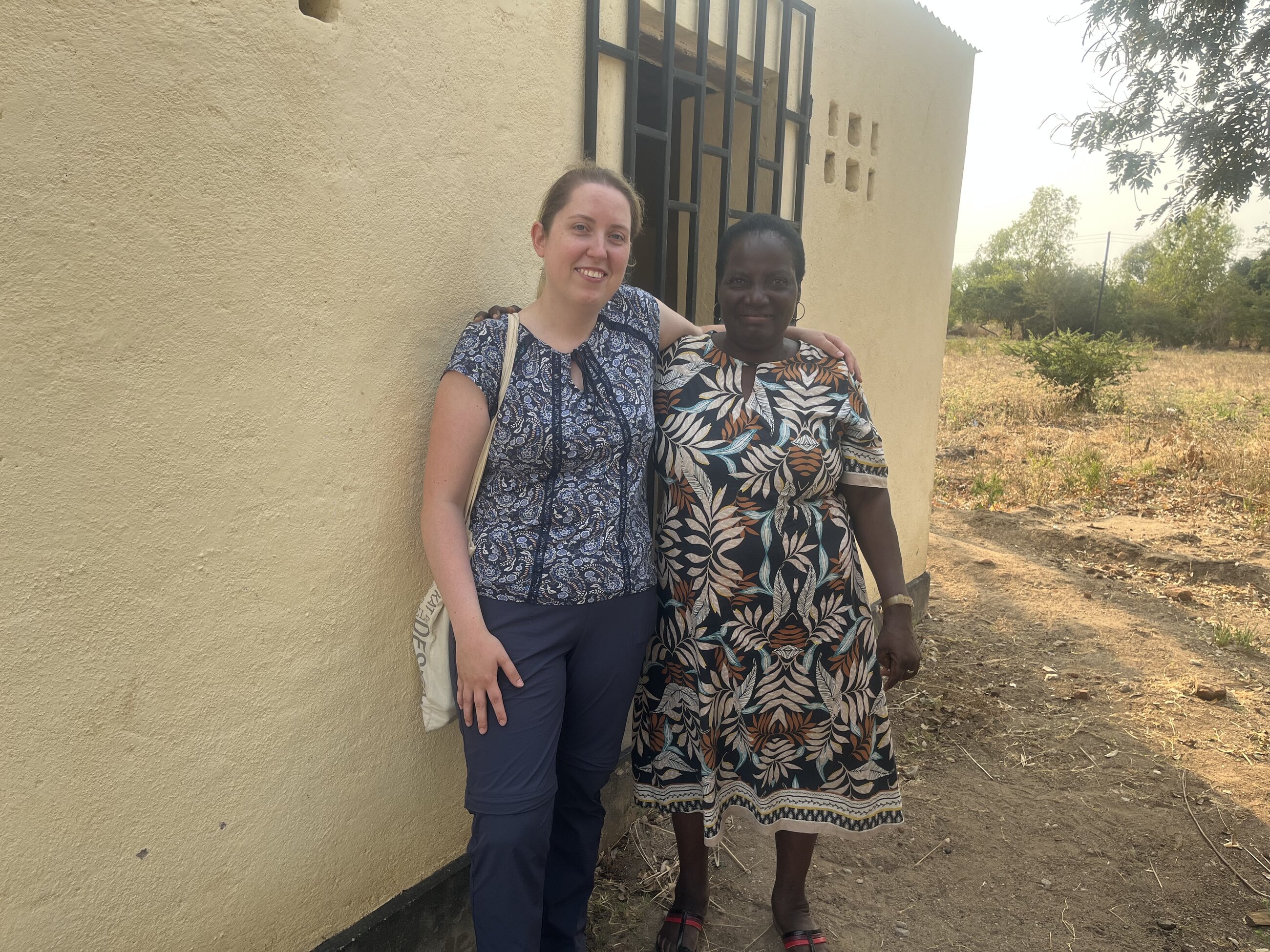 Gertrude the head teacher of Mwenilondo Primary School and me in front of the change room for girls
