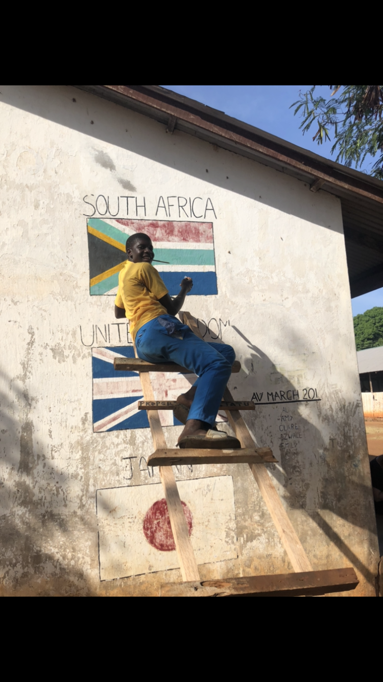 One of the children helping to paint!