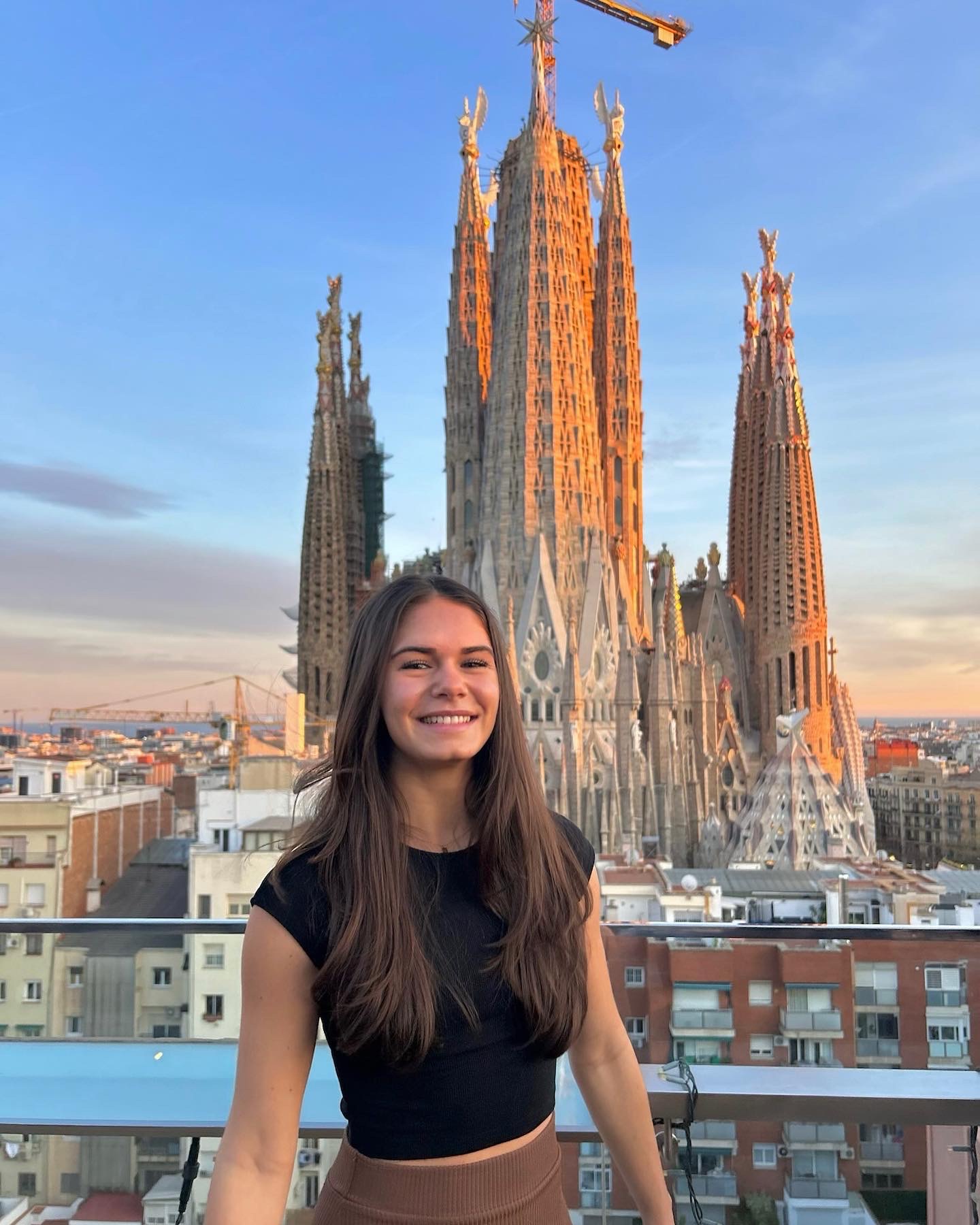 Posing for a picture at sunset with an incredible view of La Sagrada Familia