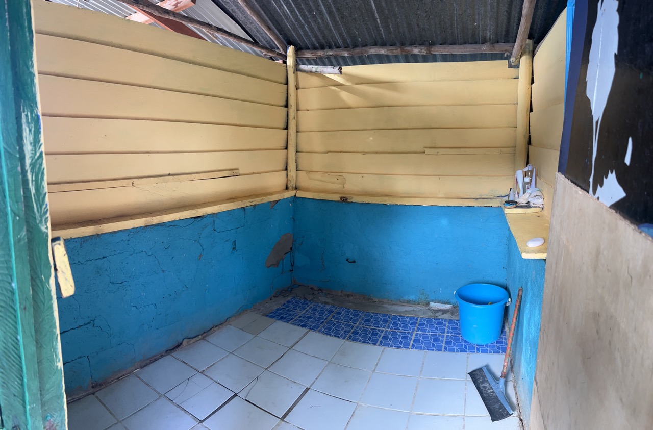 One of the 'bucket' showers. And watch your feet on the broken tiles