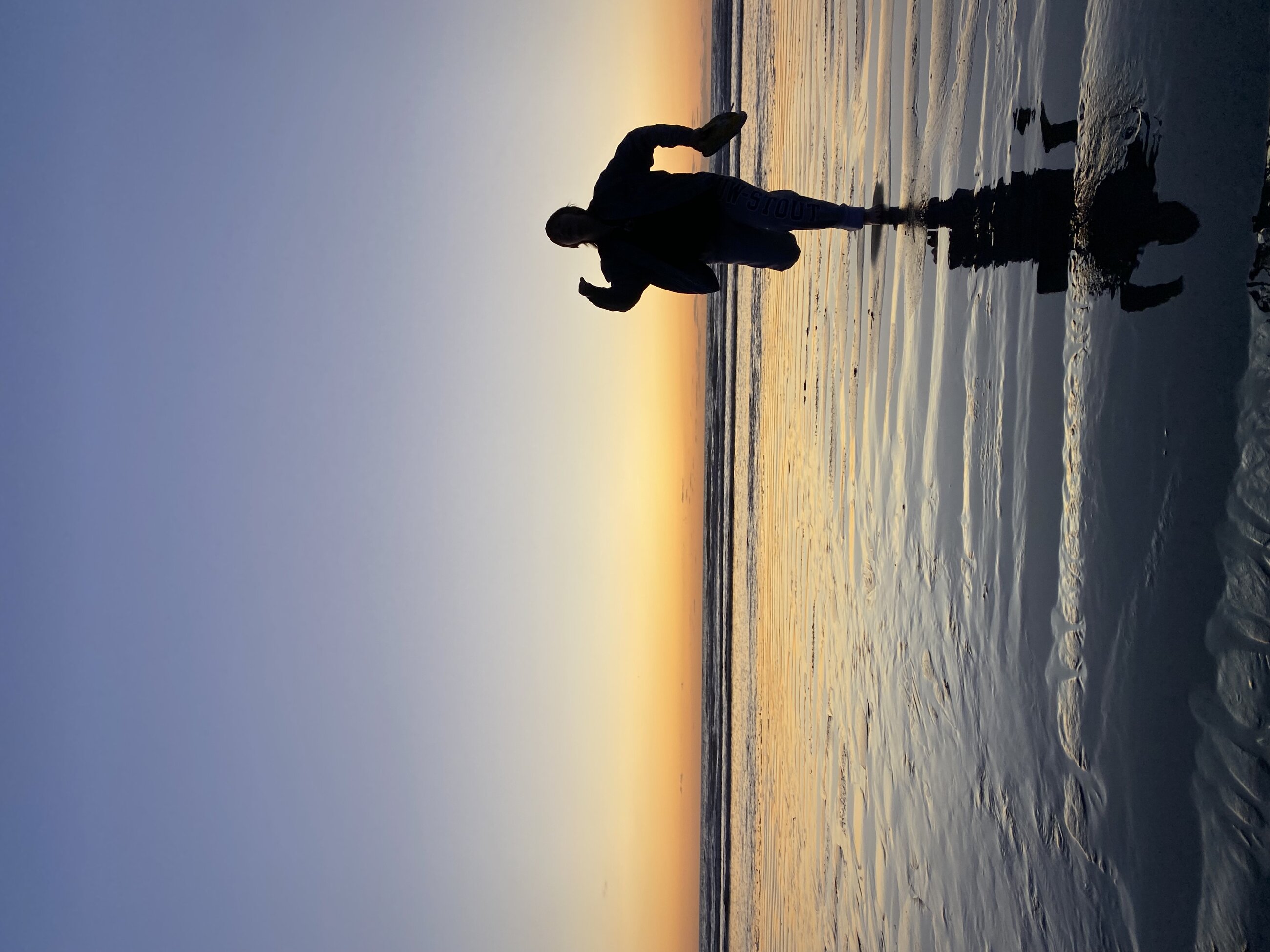 Running along beautiful Waitarere Beach at sunset