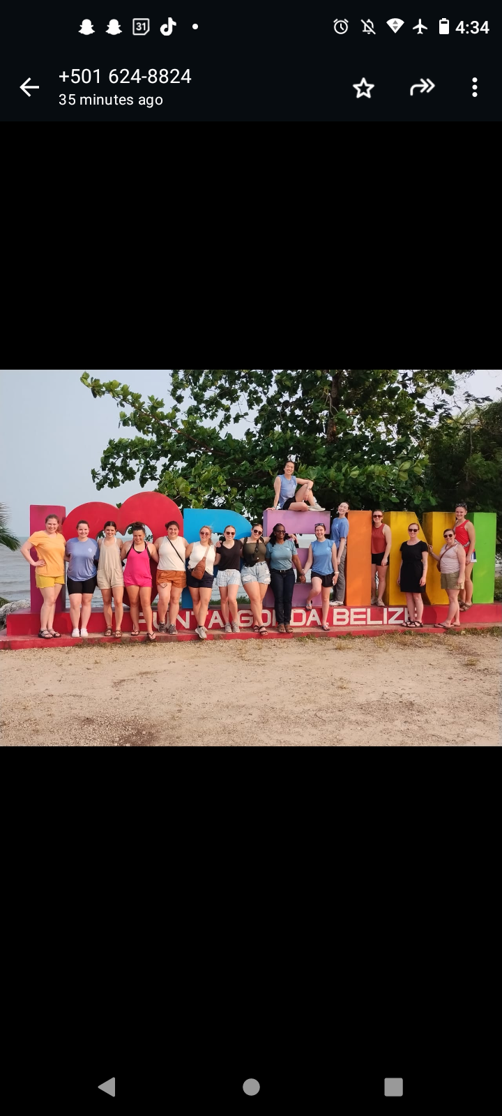The group in front of the town sign.