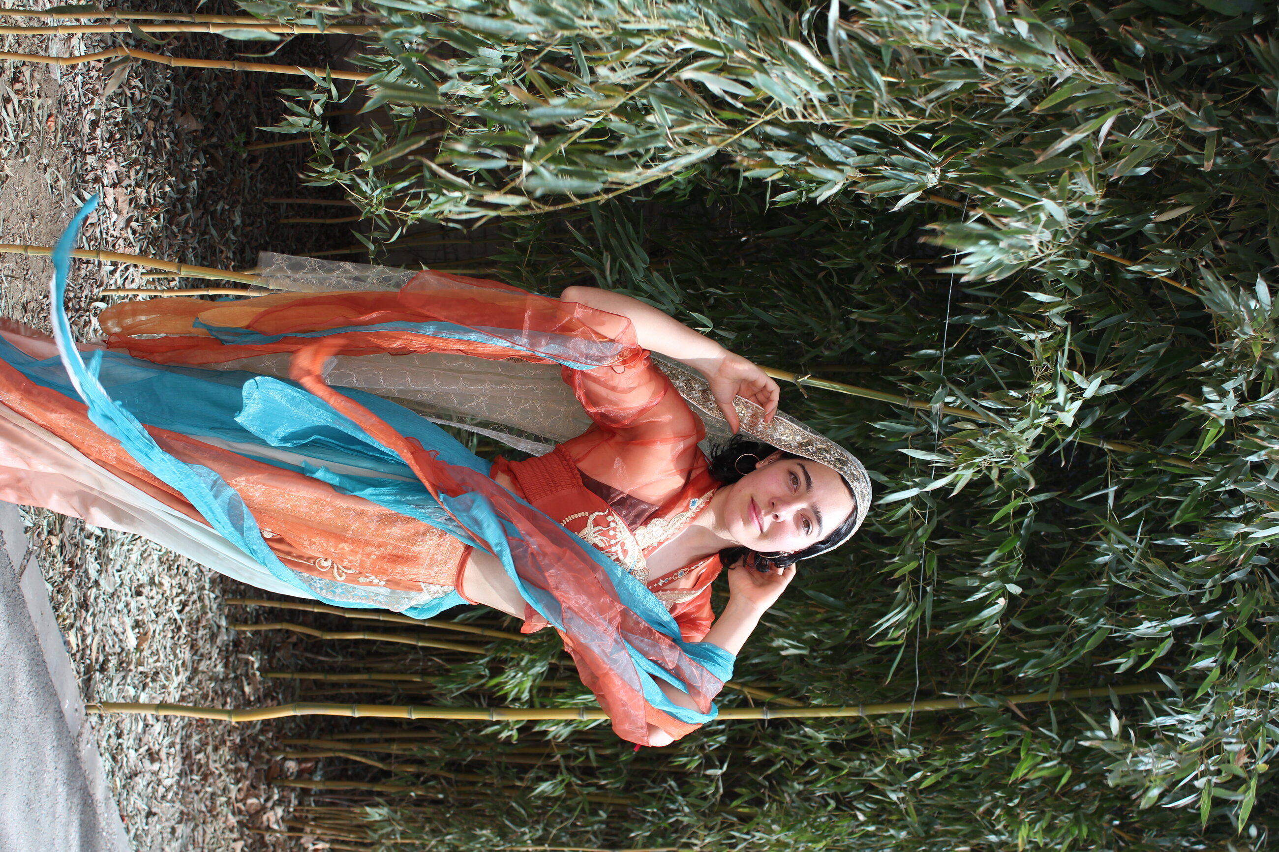 Wearing the light gown of a traditional Chinese dancer
