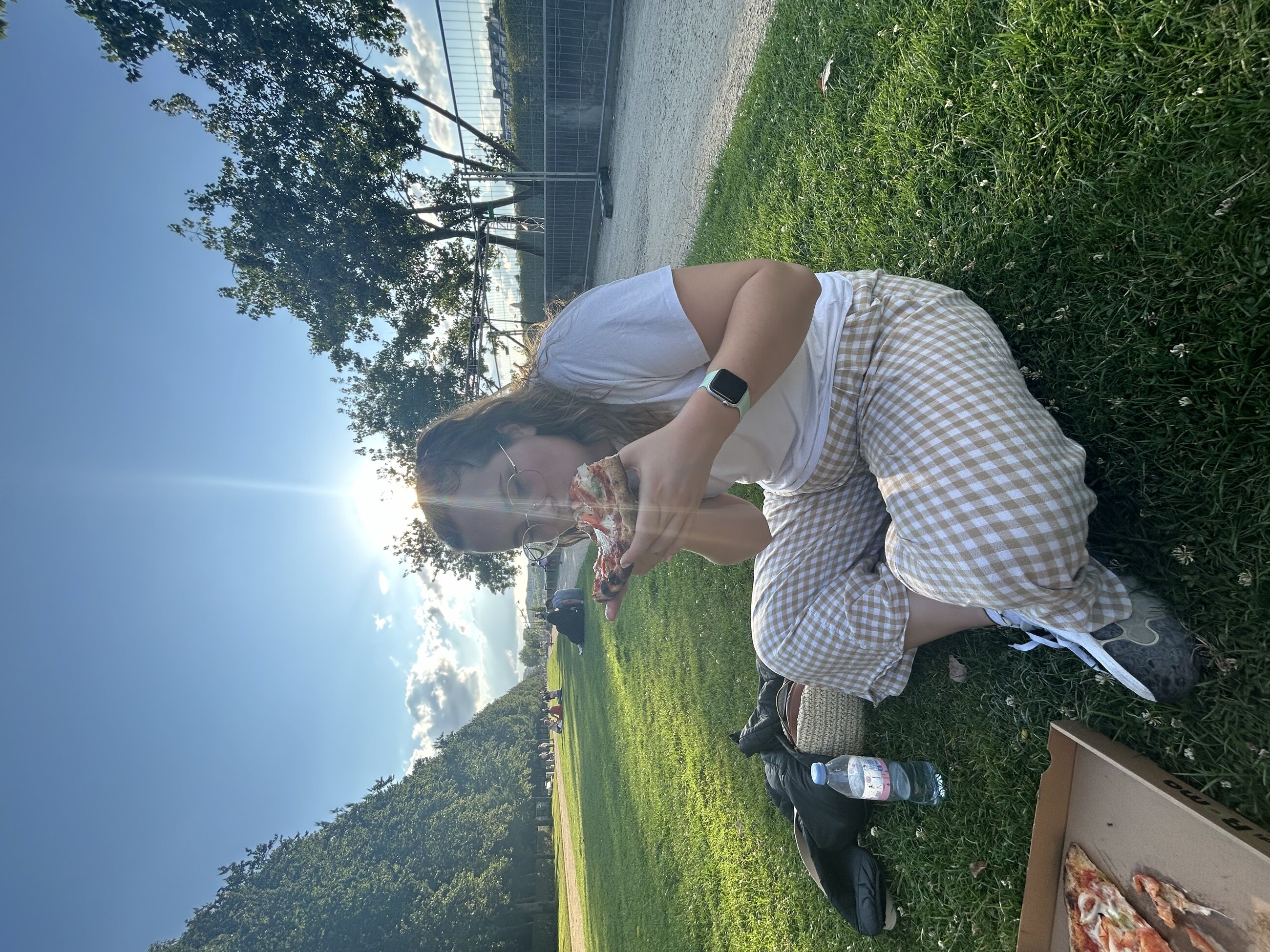 Eating pizza in the park near the Eiffel Tower