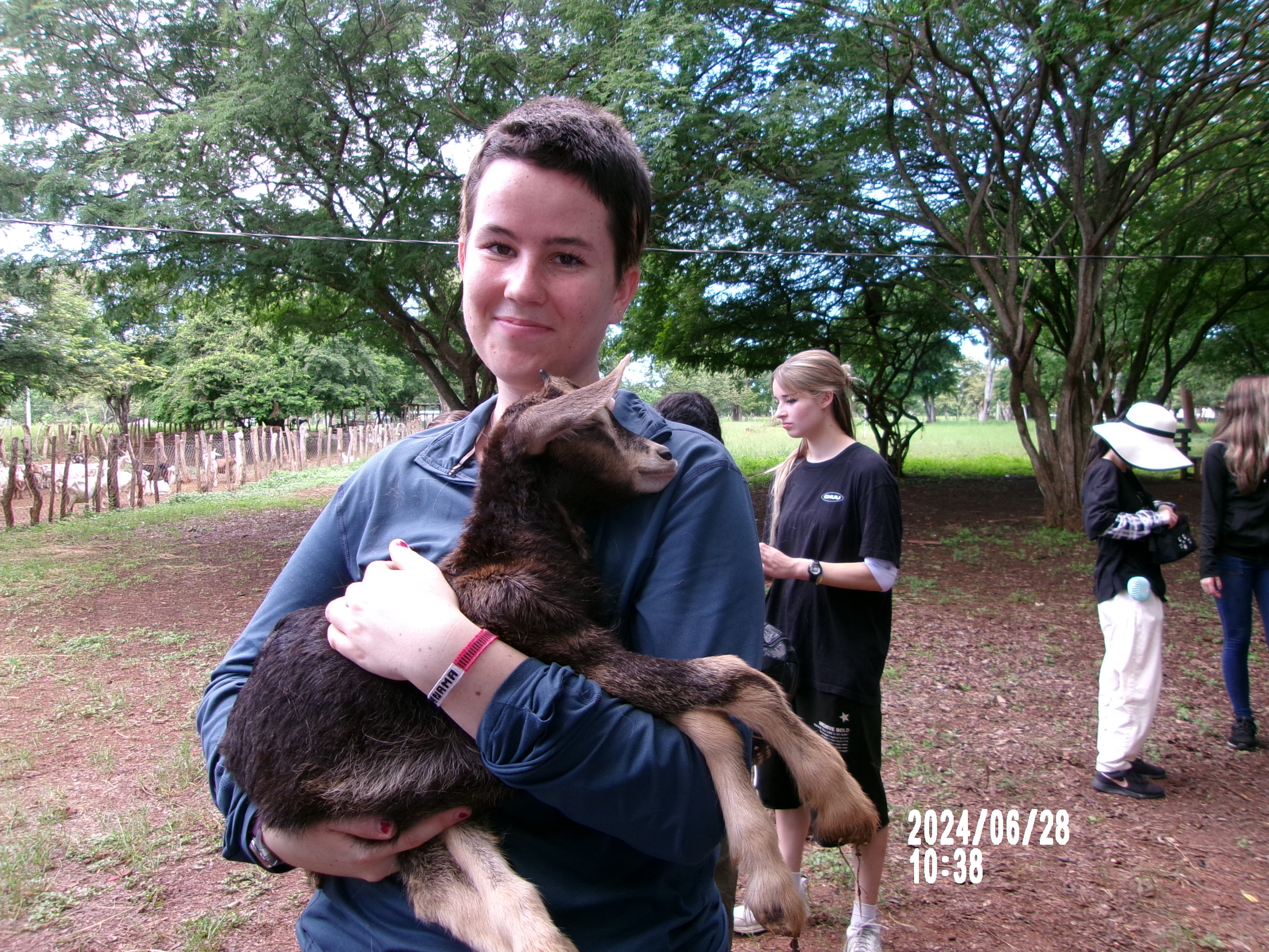 A picture of me and a baby goat on the farm