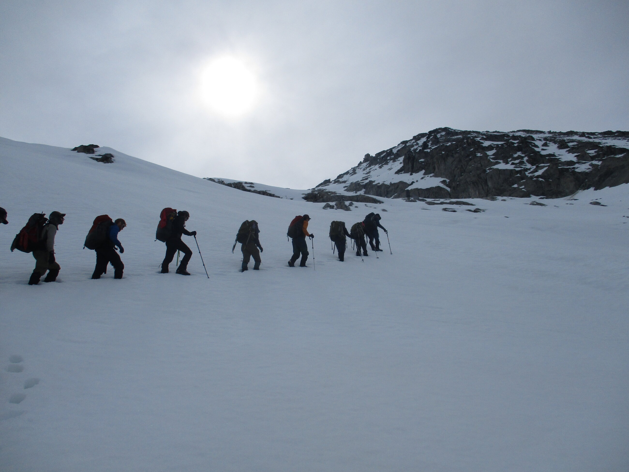 Summit snowy peaks with rope team