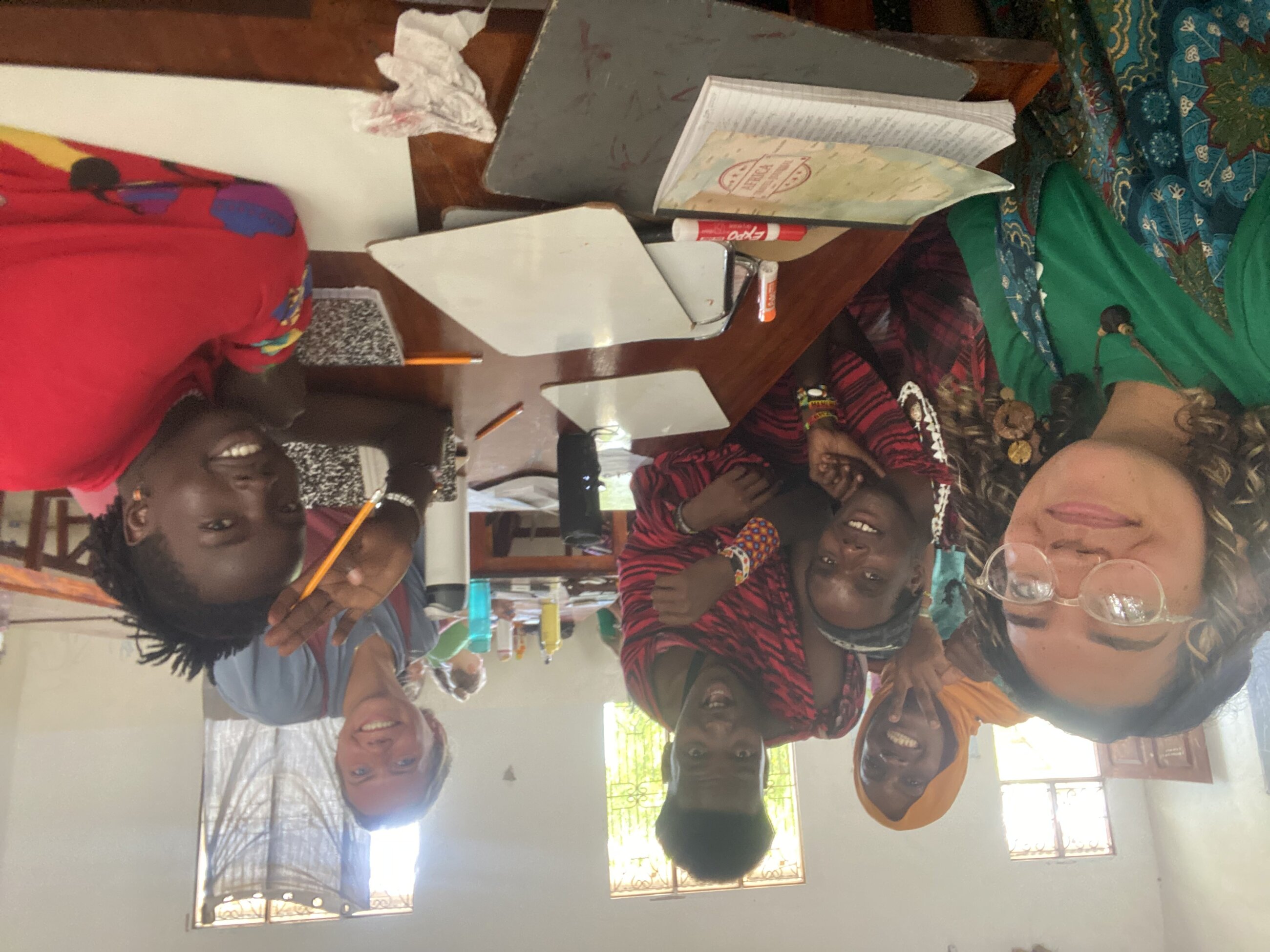 Teaching English class and learning Swahili at the YaKairo GIVE school to a group of Masai tribesmen