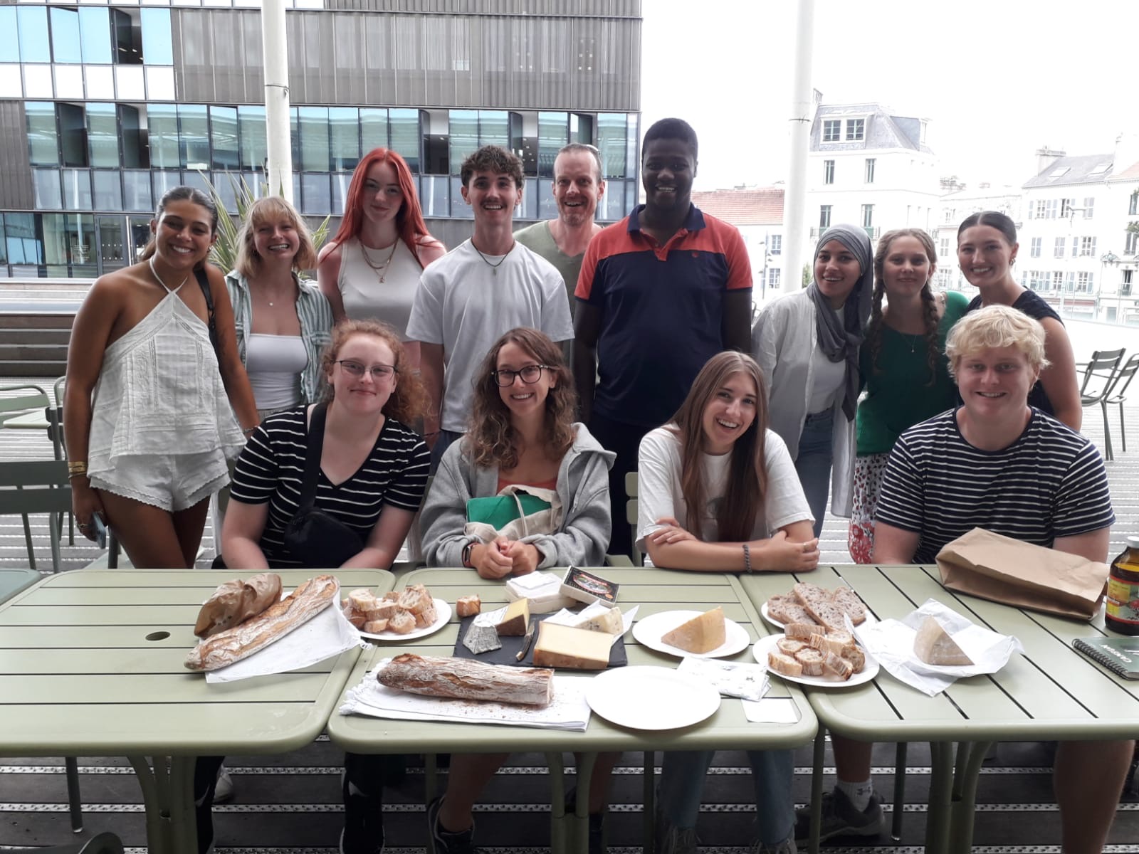 My classmates and I trying authentic French cheese and learning the correct way to cut it during our last language class of the session.