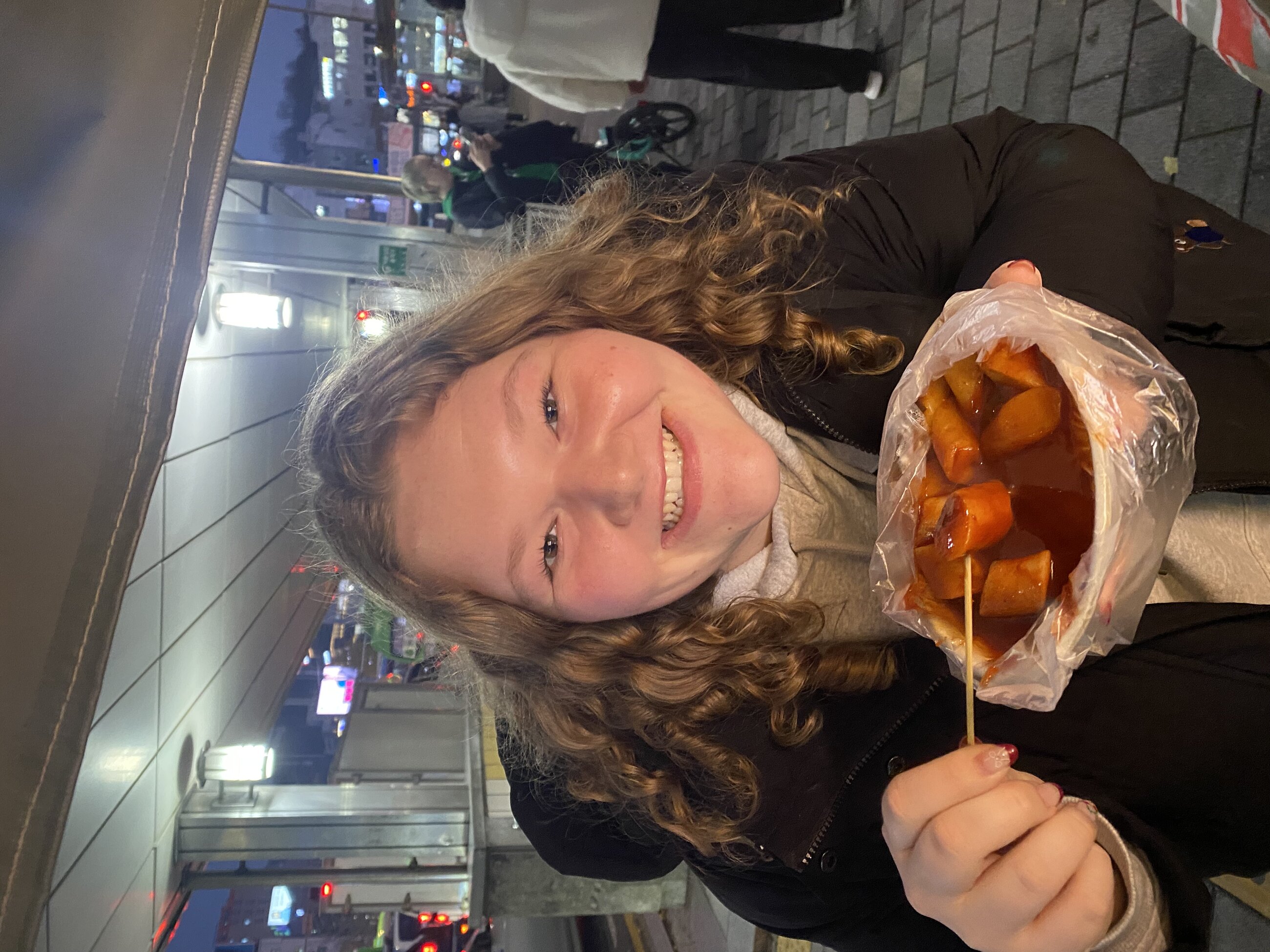 Me eating tteokbokki from a street food stand (soooo good)!