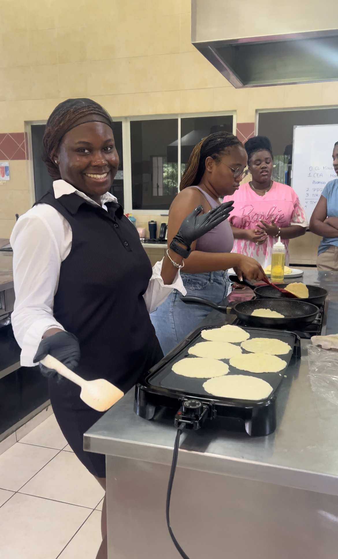 A picture of me and some of my friends making authentic tortillas during a cooking class.