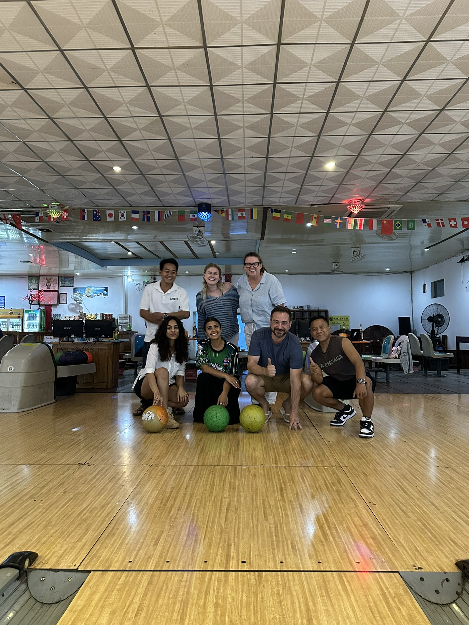 The local team and volunteers bowling in Laos