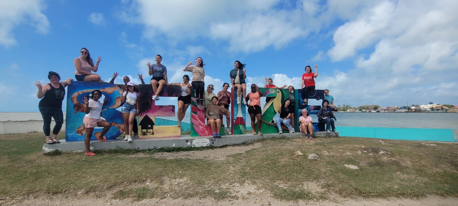 Posing in front of the Belize sign