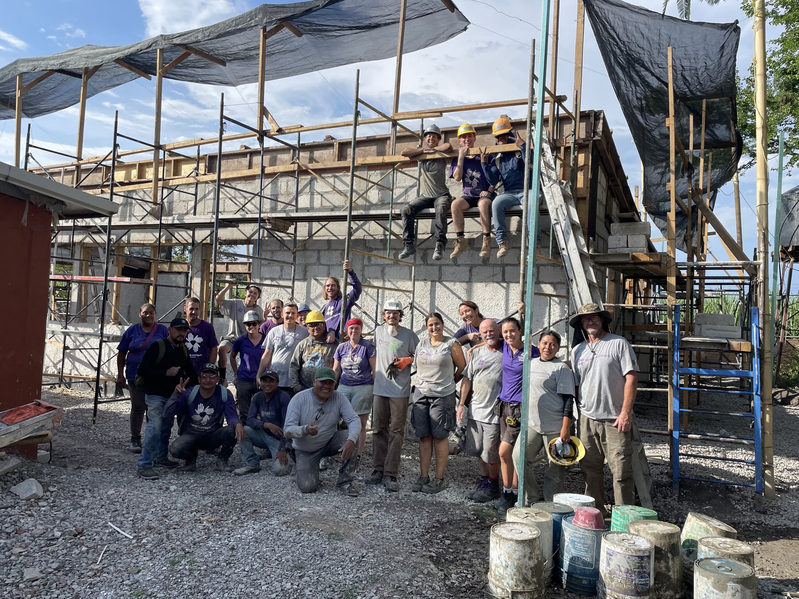 Volunteers, staff and local workers after a successful concrete pour