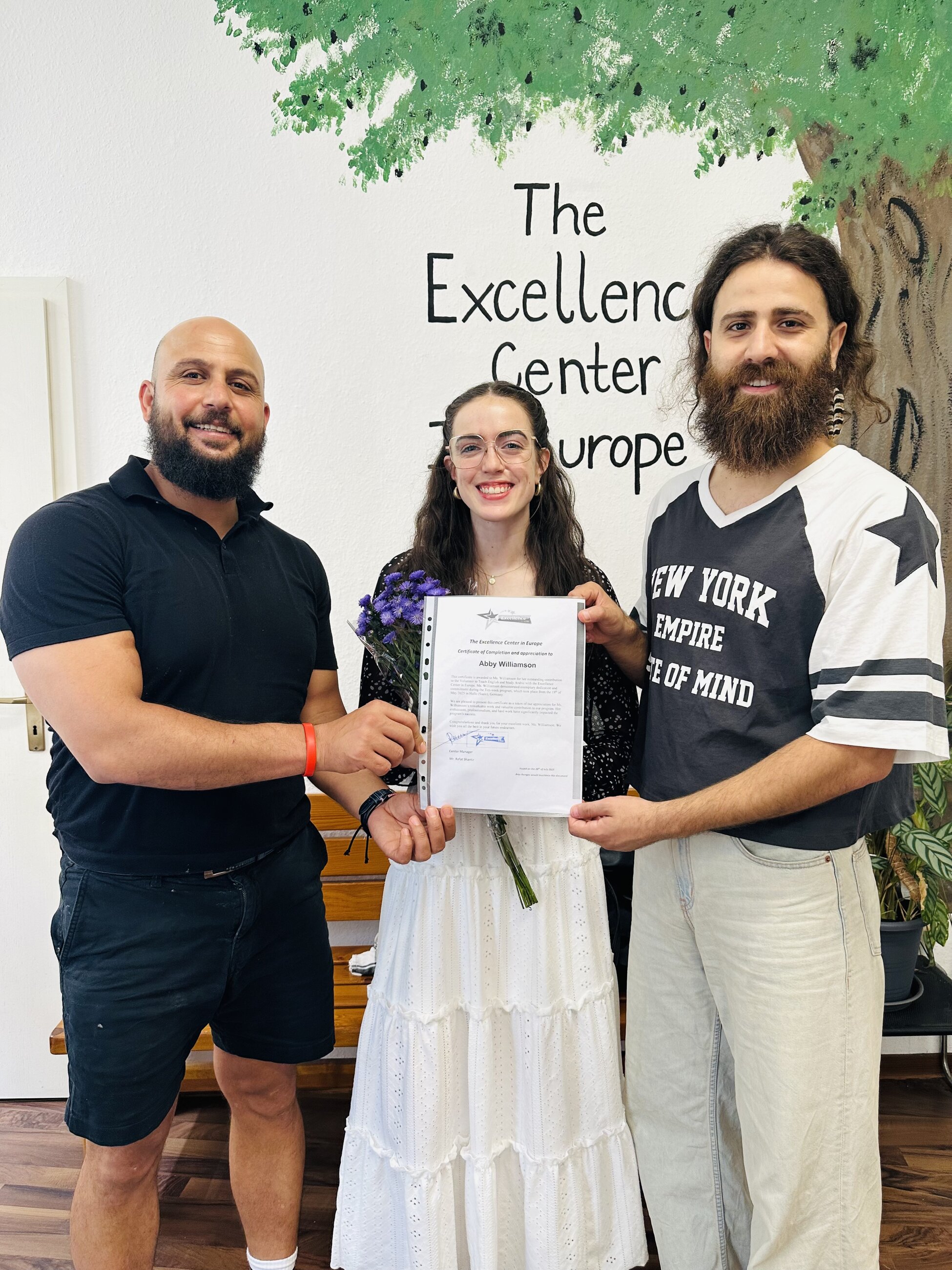 Certificate in hand and big smiles all around
