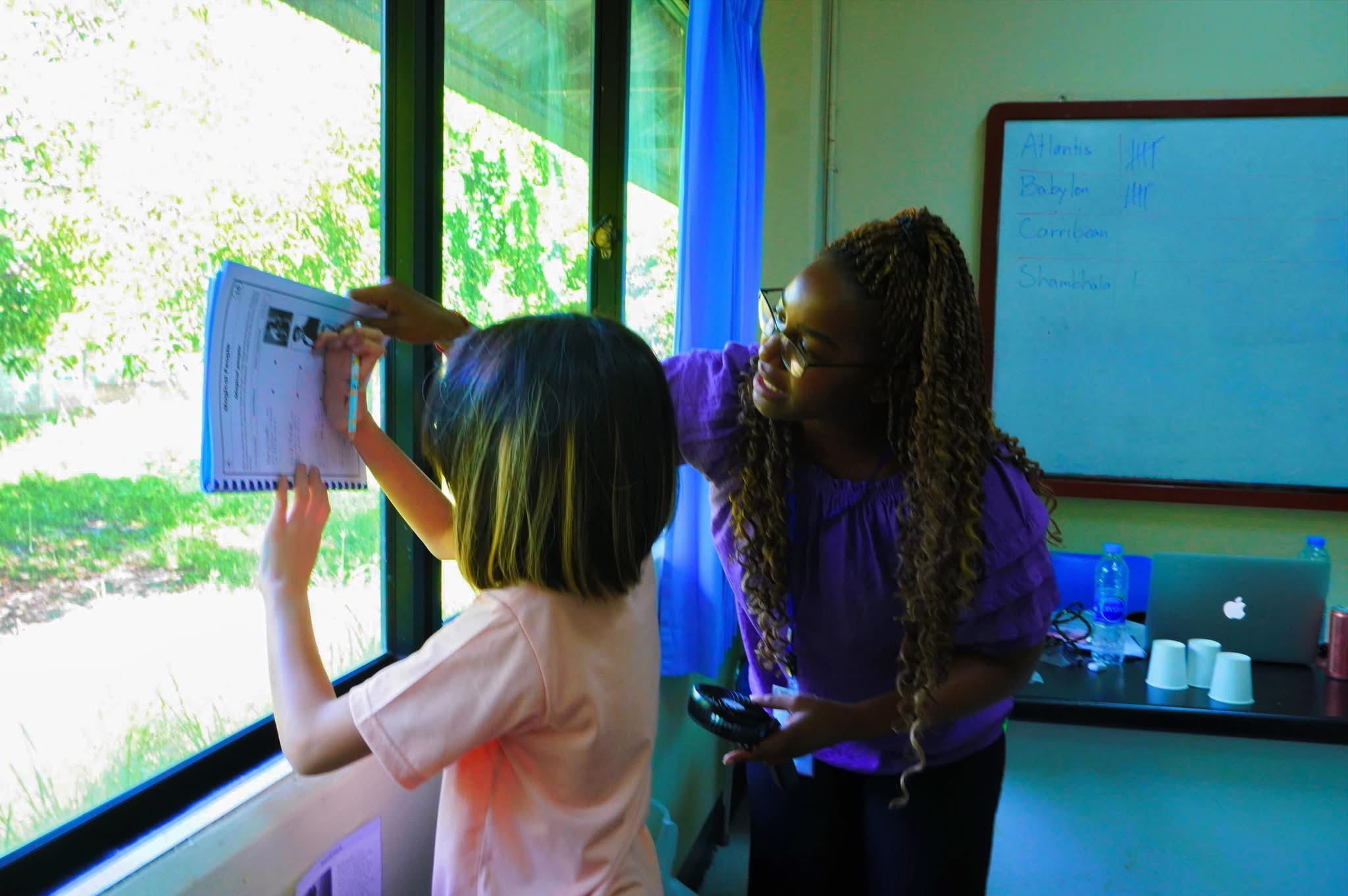 Helping a student at camp with her work