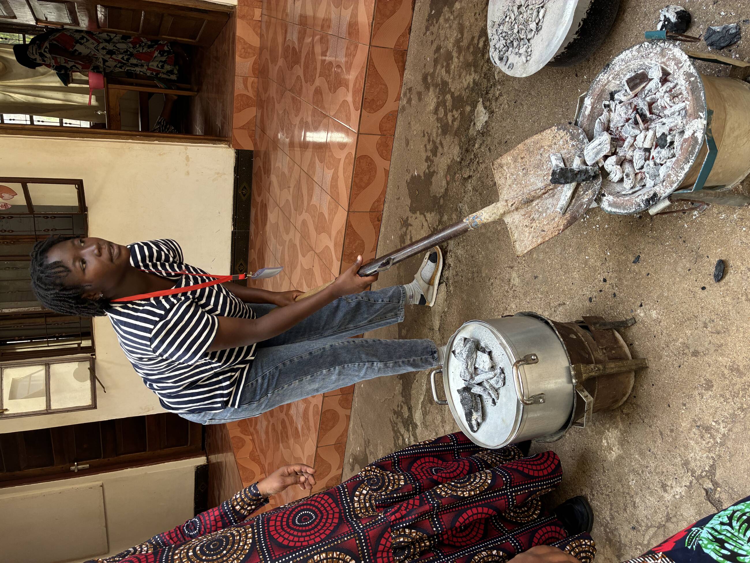 Students preparing charcoal fire to bake cake.