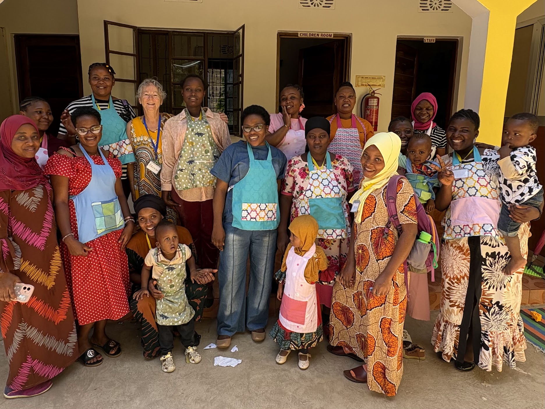 Students showing off the children’s aprons we made. 
