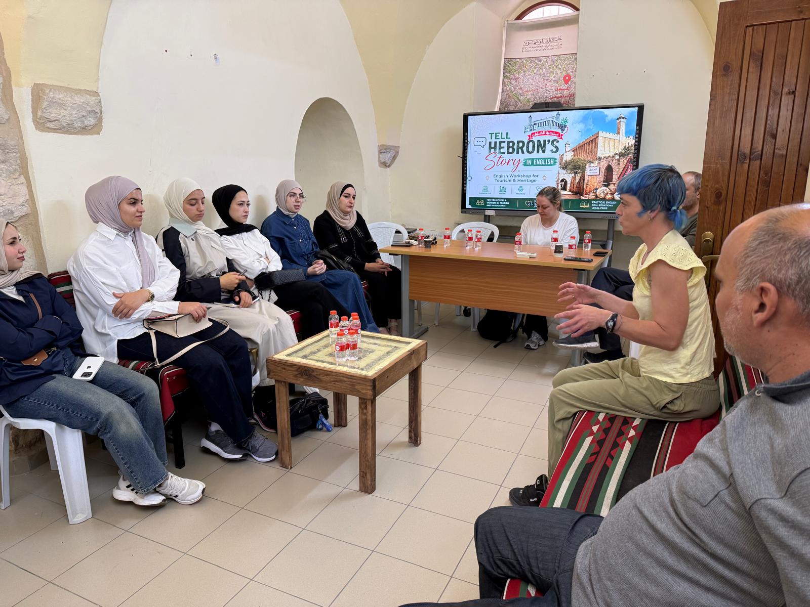 Chatting and sharing views in English with graduate tourism and architecture students at the Hebron Tourism Center