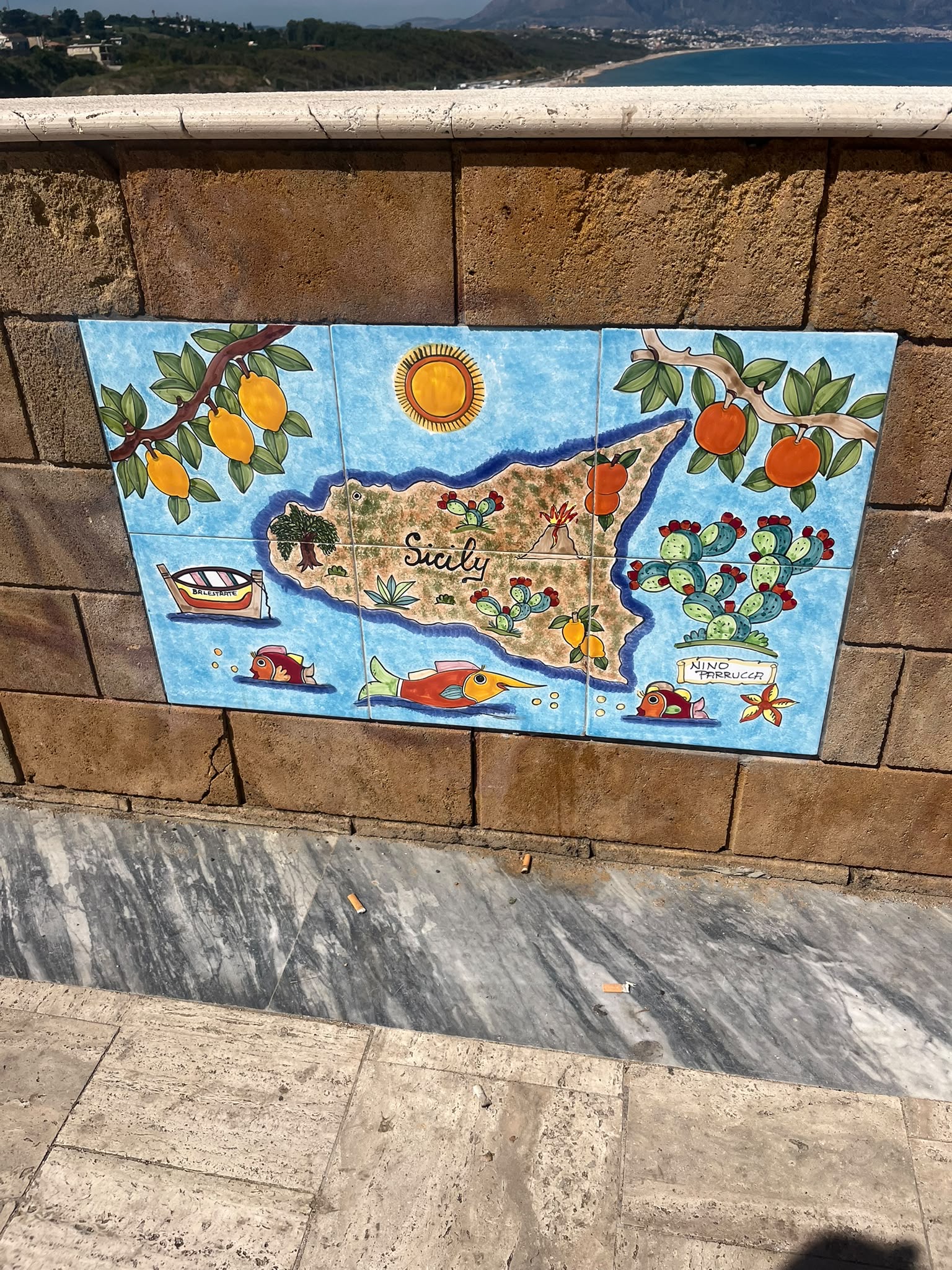 On a wall in front of the sea