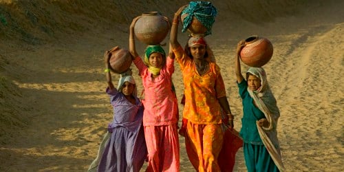 Girls carrying water in India