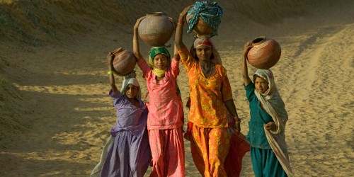 Girls carrying water in India