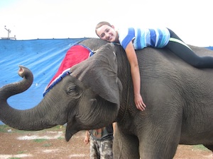 Girl laying on top of an elephant