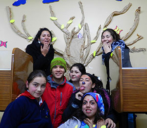 Kenneth (green hat) with his students