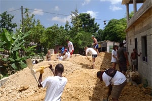 VISIONS volunteers building community structures 