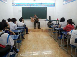 Josh playing the guitar for his students