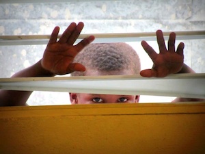 Boy looking through window in the dominican republic