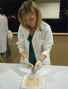 A volunteer learning how to do stiches
