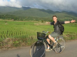 Riding on a bike through rice fields.