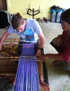 Learning how to weave a bag.