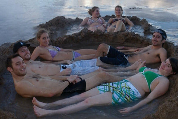 Caitlin and friends relaxing on Coromandel, a hot water beach