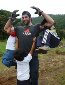 Volunteers playing with kids while helping the community