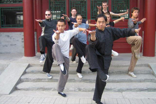 Andrew (center) with his teachers. [Photo was featured in a Beijing Magazine]