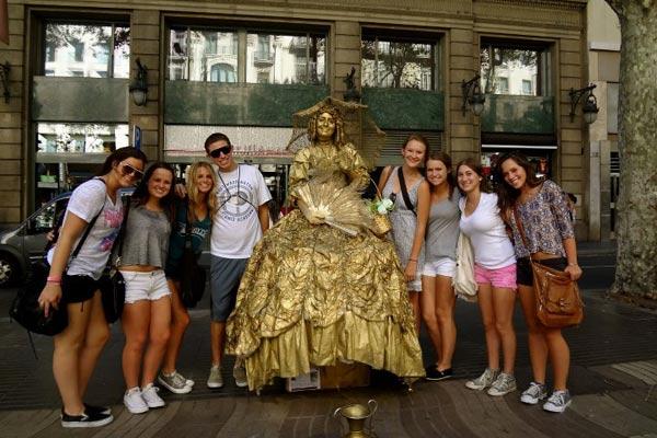 Haley and friends with a street performer in Barcelona