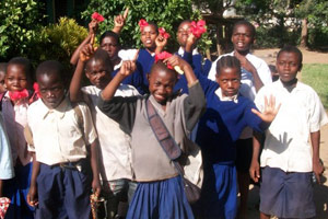 Tanzanian students presenting flowers