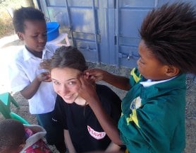 Kids braiding Lisettes hair