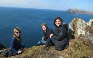 three students sitting on a cliff dingle peninsula ireland