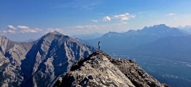 standing on top of a mountain