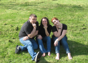 "‘Casual’ moment during extended field visit to the Republic of Ireland with two students enjoying the sunshine." A group of people posing for a picture.