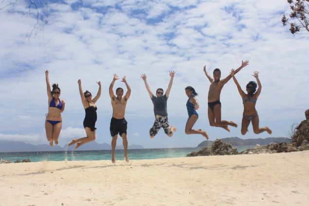 team jumping on beach