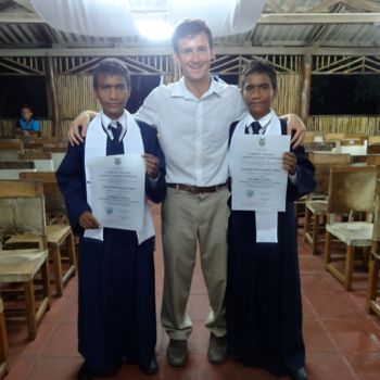 Jon at graduation with a pair of graduating twins, Alex and Elkin