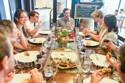 teacher eating food at a table with students