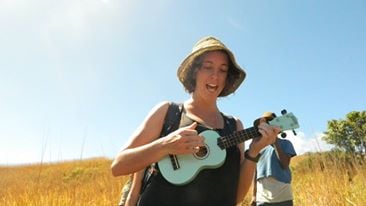 woman playing guitar outside